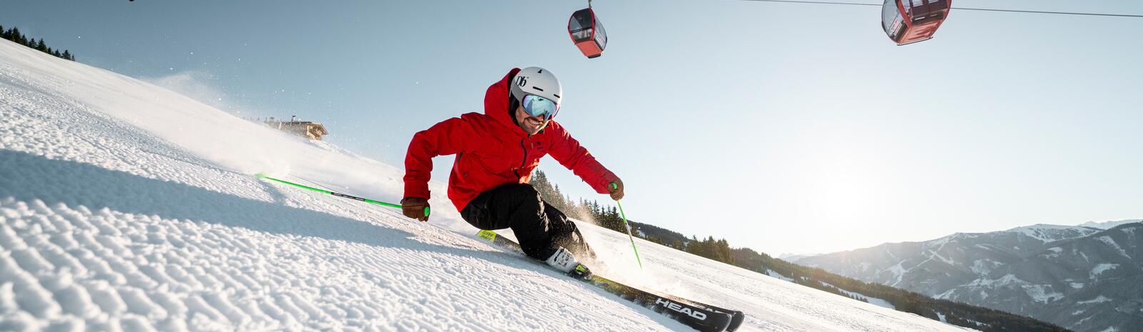 Skier on freshly prepared slope in Saalbach Hinterglemm ski resort