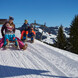Rodeln | © saalbach.com, Daniel Roos Eltern mit Kindern beim Rodeln in Saalbach | © saalbach.com, Daniel Roos