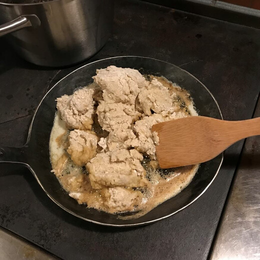 Putting the dough into the hot pan Putting the dough into the hot pan
