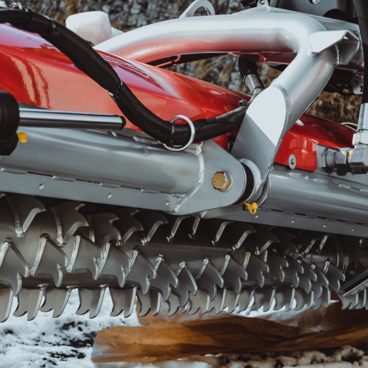 The tiller at the rear end of the piste groomer